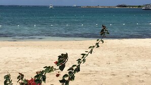 A beach with a sandy shore and a clear view of the sea. - Avisa Stays. A hidden gem. Luxury beach living.  (Ocho Rios)