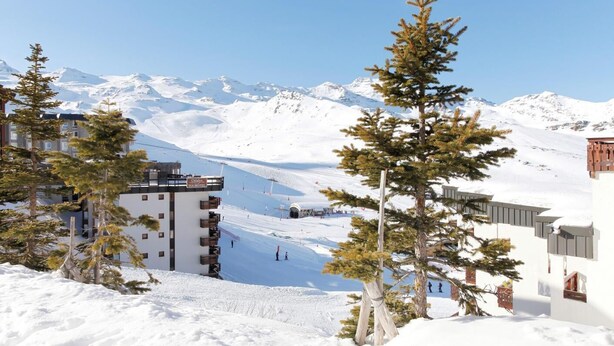 A snow-covered mountain resort with a hotel named "Othlet's Tourhotel" and ski slopes in the background. - 300m from resort center, tv, ski locker, 16m², Val Thorens (Val Thorens)