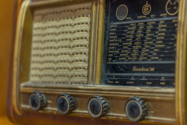 A vintage radio with a list of cities and corresponding frequencies.