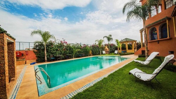 Seasonal outdoor pool, pool umbrellas, pool loungers