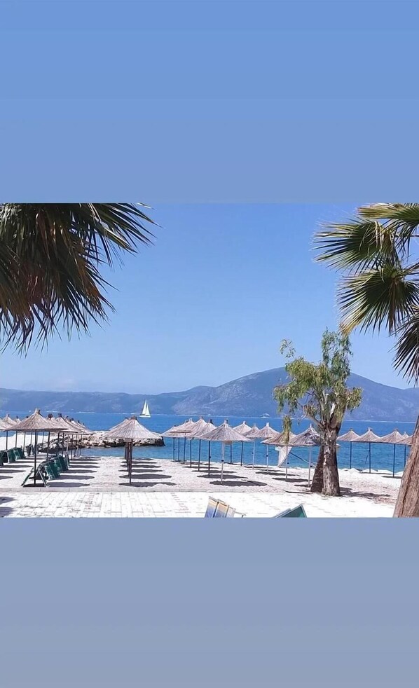 Private beach, black sand, sun loungers, beach umbrellas