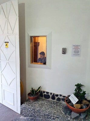 A clean, modern entrance with a white door, a small window, and a potted plant. - B&B Cappotto Civico 48 (Pompei)
