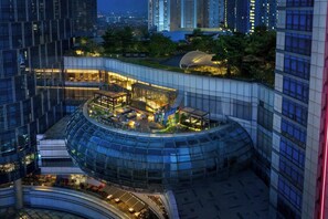 A modern hotel with a curved glass facade, rooftop garden, and multiple dining areas. - Four Points by Sheraton Surabaya, Pakuwon Indah (Surabaya)