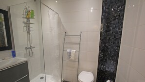 A modern bathroom with a glass-enclosed shower, a white toilet, and a metal towel rack. - T2 fully equipped near all amenities bus, tram, train station, city center (Nice)