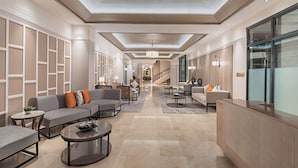A spacious lobby with a modern design, featuring sofas, armchairs, and a reception desk. - Dusit Thani Residence Davao (Davao)