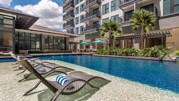 Outdoor pool, open 7:00 AM to 7:00 PM, pool umbrellas, pool loungers
