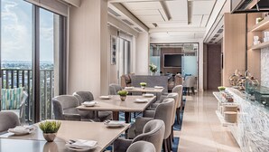 A modern hotel dining area with large windows, a bar, and a view of the city. - Dusit Thani Residence Davao (Davao)