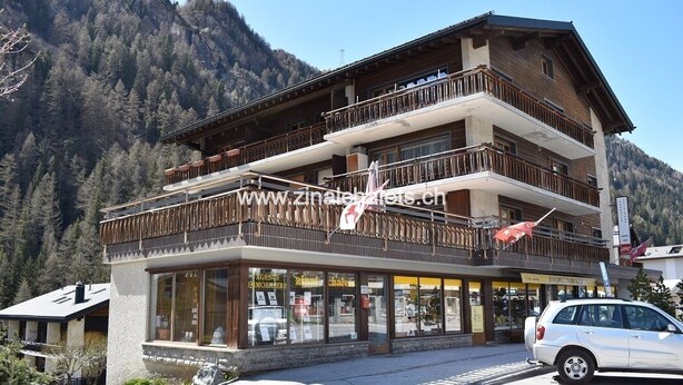 A multi-story building with balconies and large windows, situated in a mountainous area. - Appartment in a building in Zinal - 2 beds in the living room - TV broadcasting - kitchen - 1 bathro (Zinal)