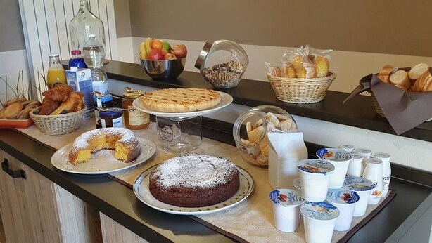 A breakfast buffet with various pastries, cakes, and beverages. - B&B Le Strade del Gavi (Francavilla Bisio)