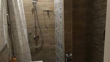 Shower, rainfall showerhead, bidet, towels