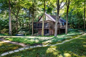 Escape to a secluded cabin nestled in a lush forest, surrounded by nature's tranquility.