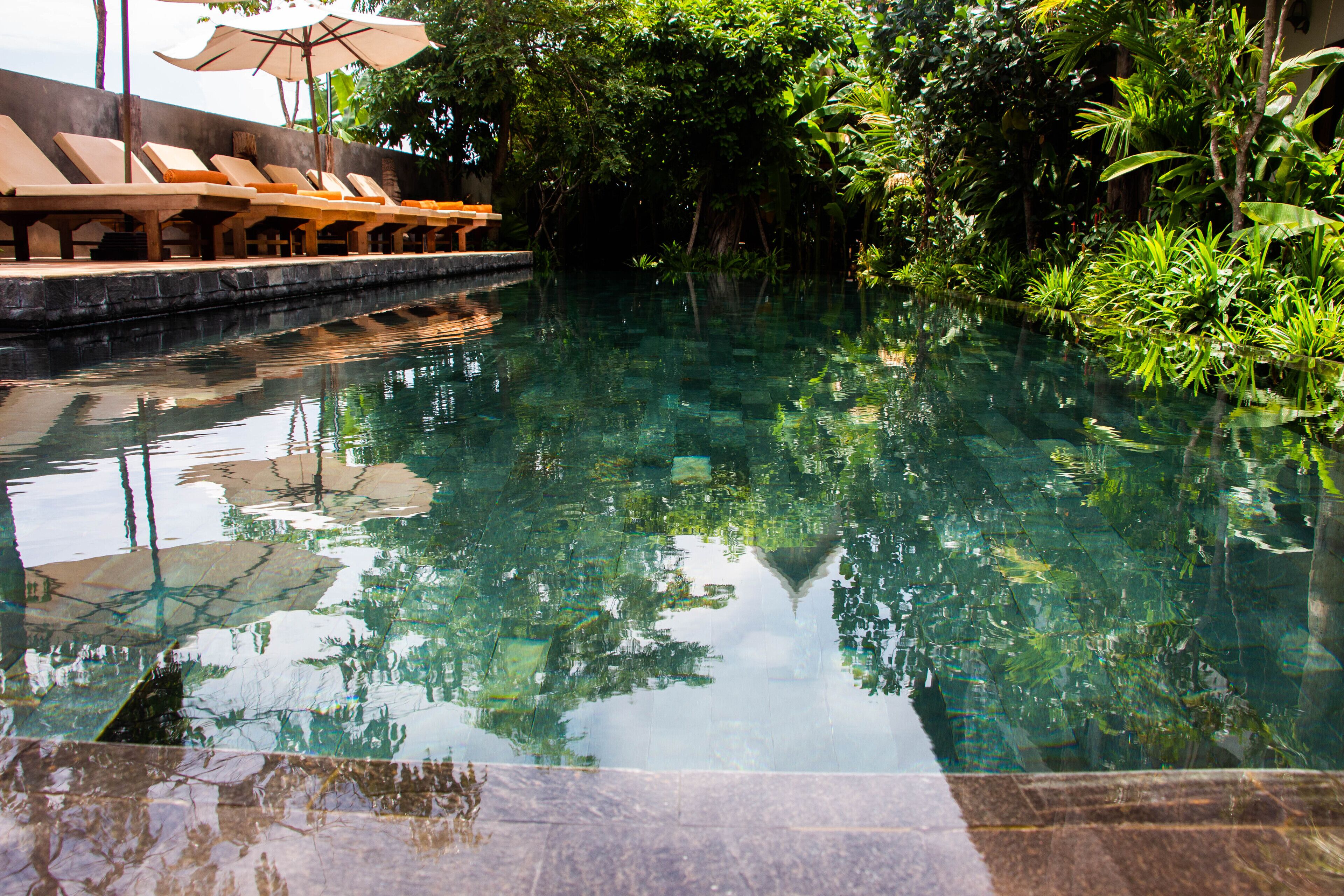 Outdoor pool, open 6:00 AM to 10:00 PM, pool umbrellas