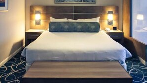 A hotel room with a large bed, two bedside tables with lamps, a bench at the foot of the bed, and a painting on the wall. - 1BD/Vegas - Pool, Hot Tub, and Shuttle to the Strip! (Las Vegas)