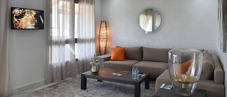 A modern living room with a sofa, coffee table, and a decorative lamp.
