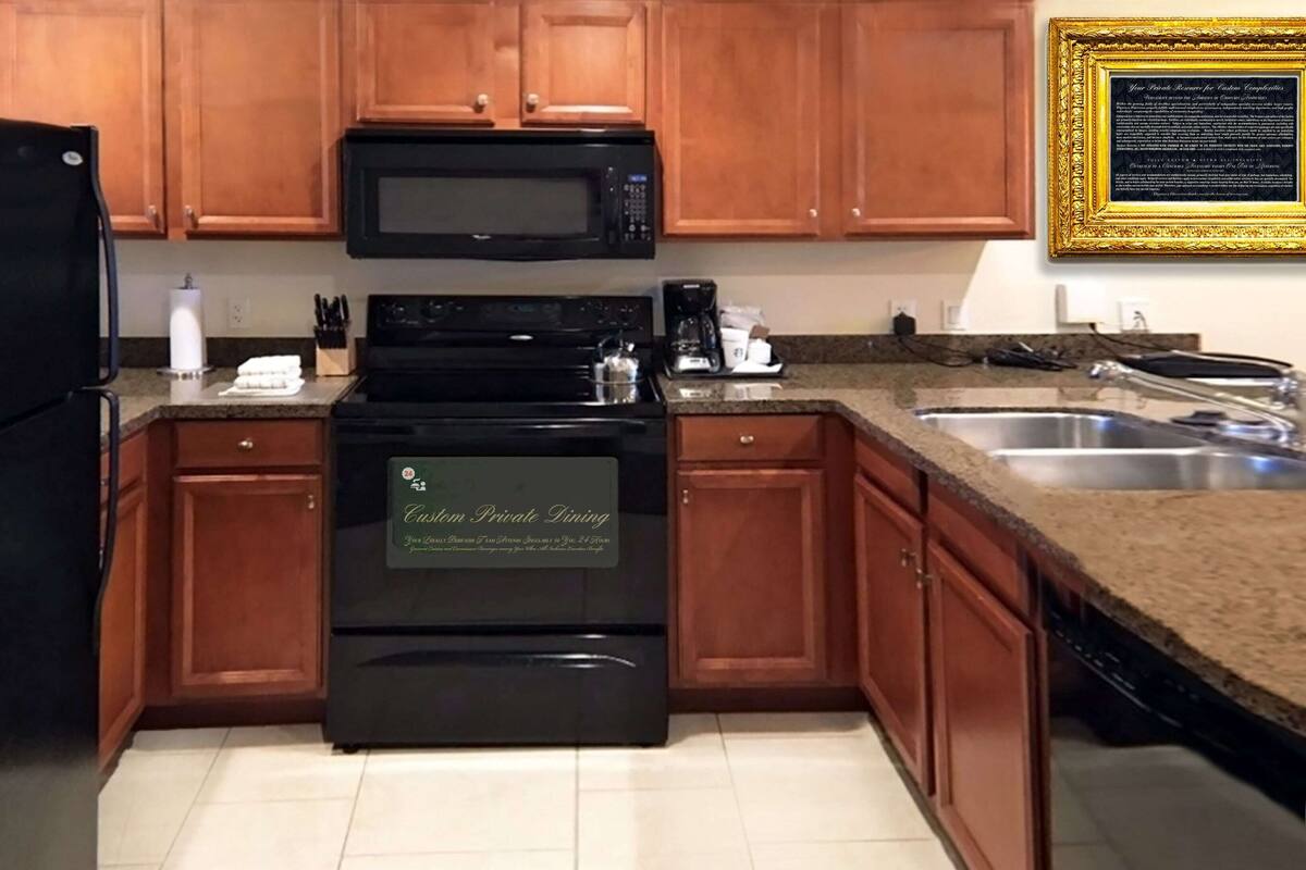 A kitchen with wooden cabinets, a black refrigerator, a microwave, a stove, and a sink.