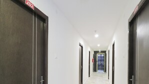 A hallway with doors numbered 202 and 209, leading to rooms. - OYO Flagship 16390 Chukkapalli Chambers (Vijayawada)