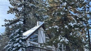 A multi-story lodge with a balcony, surrounded by snow-covered trees. - Bear Mountain Chalet #639 (Big Bear Lake)