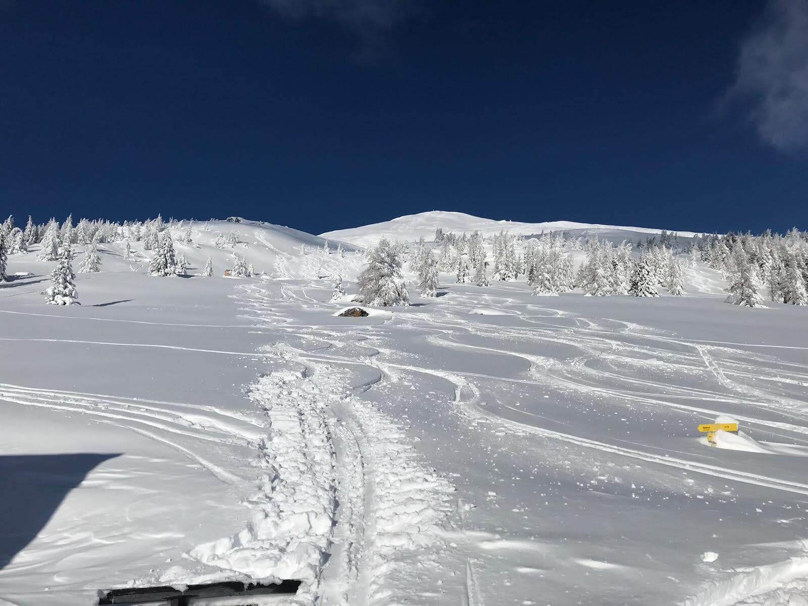 A snowy mountain landscape with clear skies.
