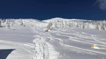 A snowy mountain landscape with clear skies.