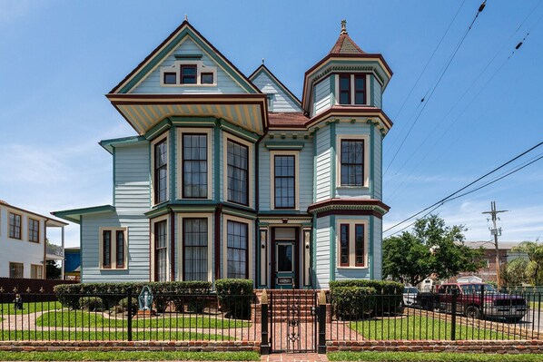 A Victorian-style house with a prominent bay window, a turret, and a front porch.