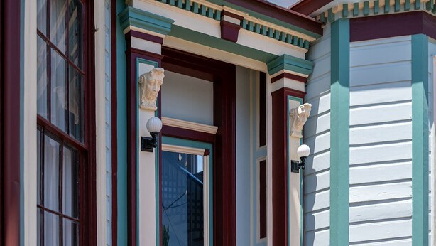 A building with a traditional architectural style, featuring a prominent entrance with a decorative archway and a large window.