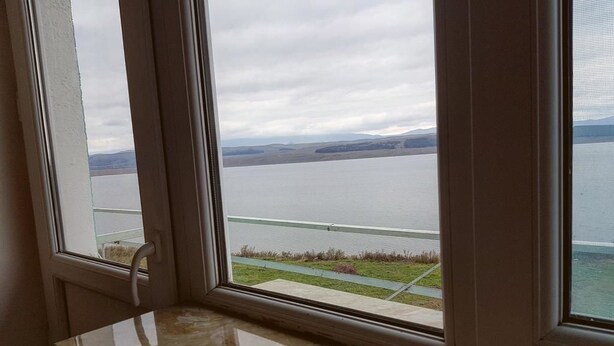 A view from a window with a view of a body of water and distant land. - Hotel Tsalka (Tsalka)