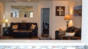 A living room with a fireplace, two sofas, a coffee table, and a lamp. - Colorado Getaway w/ Hot Tub & Fire-pit Sleeps 16+ (Northglenn)