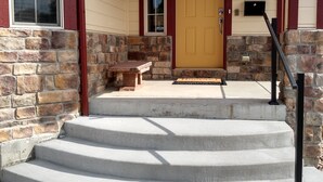 A house with a stone facade, a wooden front door, and a mailbox. - Colorado Getaway w/ Hot Tub & Fire-pit Sleeps 16+ (Northglenn)