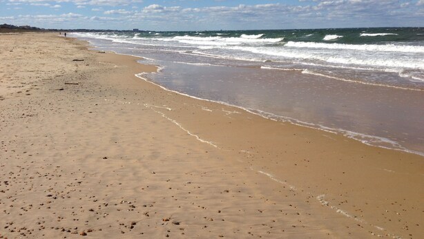 A sandy beach with waves, a clear sky, and a distant shoreline. - 2 Blocks to Beach, 5 Beds, Deck, Grill, Fire Pit, Stocked Kitchen, FIOS (Norfolk)