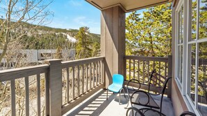 A balcony with a view of a mountainous landscape, a wooden railing, and a table with chairs. - Private Balcony w/ Mountain Views in River Run, Short Walk to Everything! (Keystone)