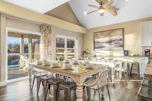 A spacious kitchen with a large island, modern appliances, and a view of the outdoors.