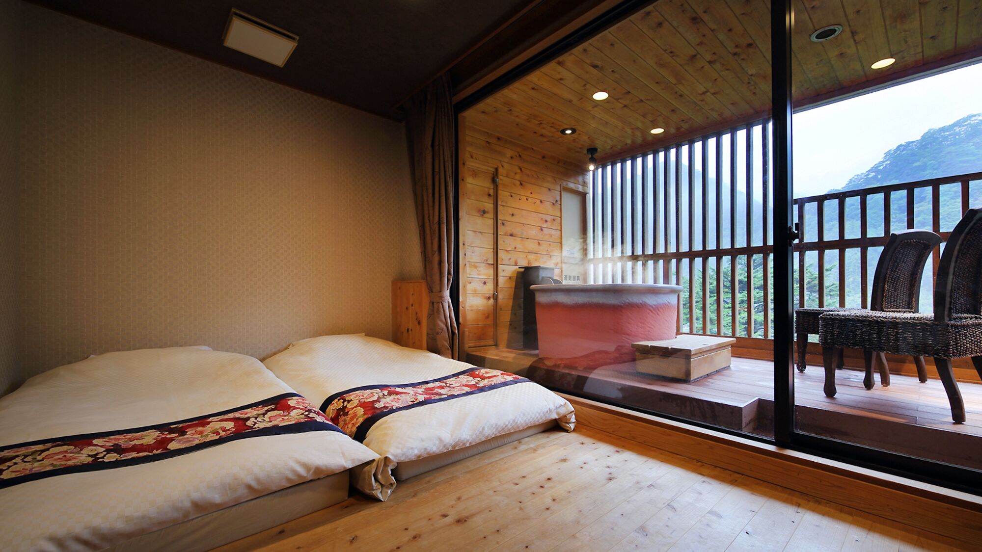 A room with a bed, a large window, and a view of the outdoors.
