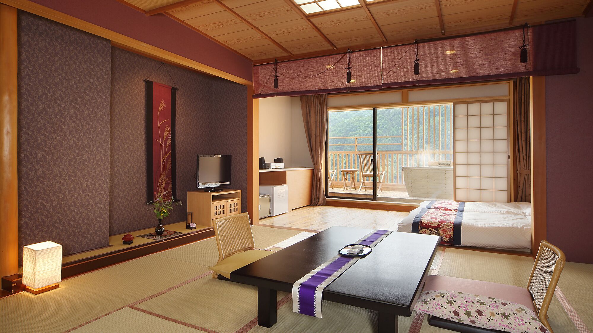 Una habitación tradicional japonesa con suelo de tatami, una mesa baja, un televisor y una puerta corredera que da a un balcón exterior.