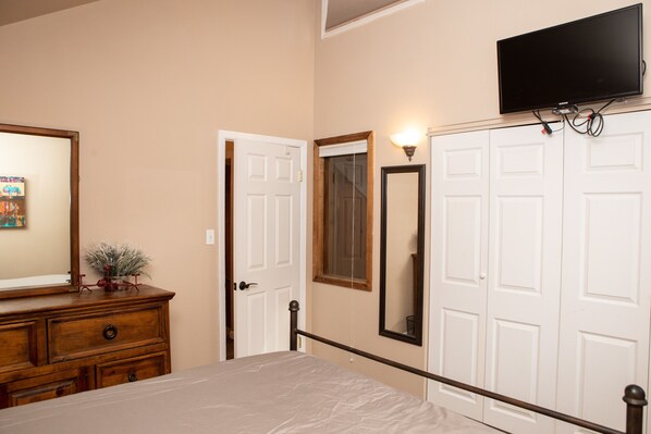 A bedroom with a bed, dresser, wardrobe, and a mounted television. - 6 Chamonix Lane 3 Bedroom Townhouse by RedAwning (Vail)