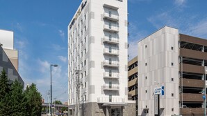 A SuperHotel Premier building with a modern design, multiple floors, and a parking garage. - Superhotel Premier Obihiro ekimae (Obihiro)