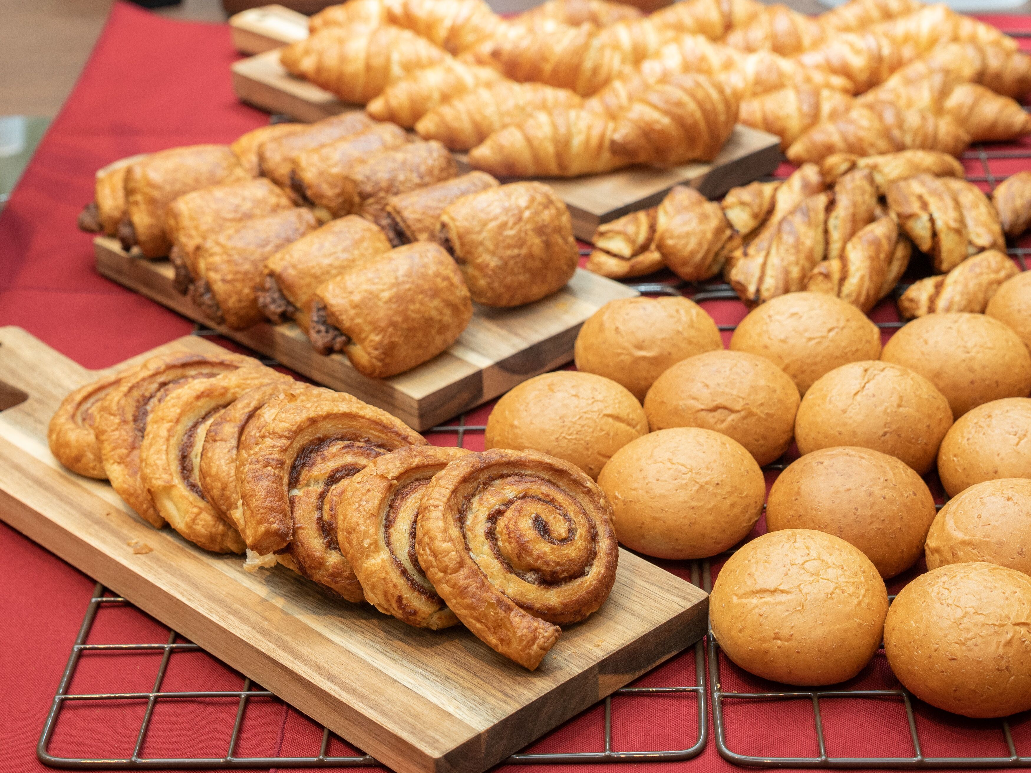 A variety of baked goods displayed on wooden boards.