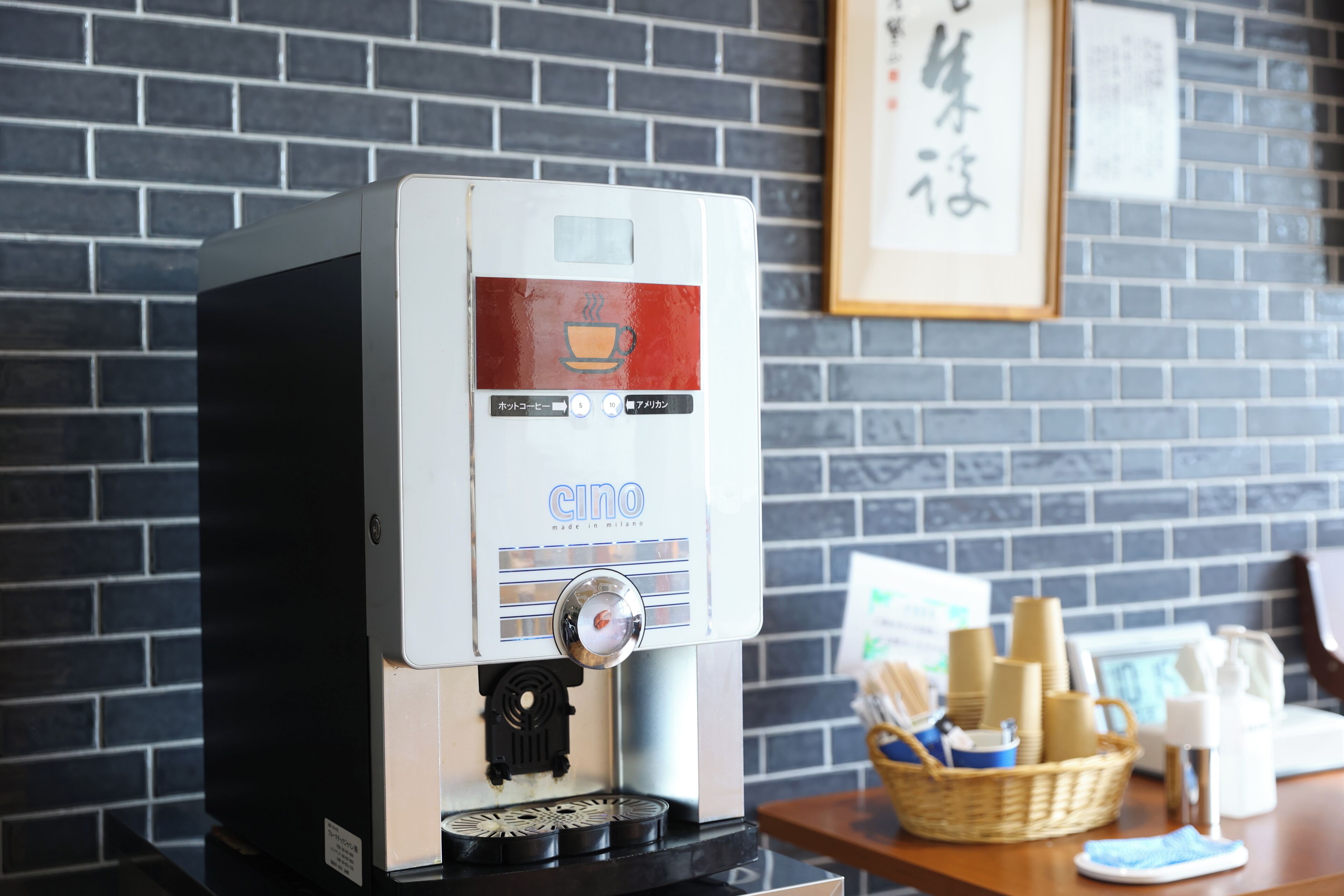 A coffee machine with a digital display, buttons, and a coffee cup icon.