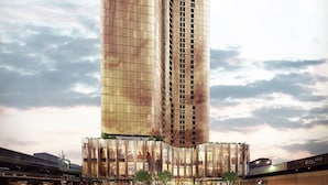 A modern high-rise building with a curved facade, large windows, and a base with a landscaped area. - Sky One Apartments by CLLIX (Box Hill)