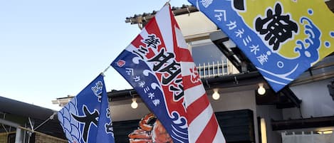 A building with multiple flags and a traditional Japanese design.