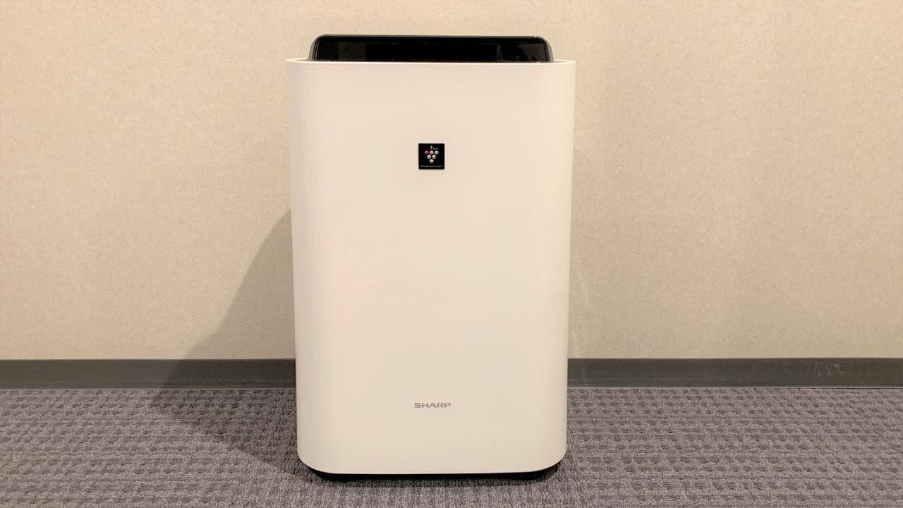 A white, modern air purifier with the brand name 'SHARP' on the bottom.