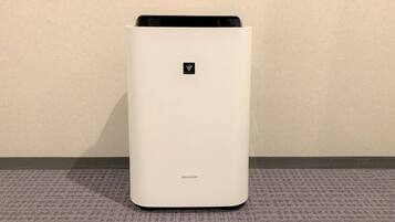 A white, modern air purifier with the brand name 'SHARP' on the bottom.