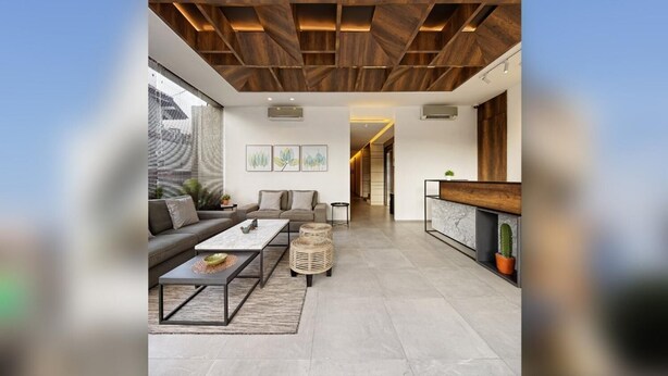 A modern living room with a sofa, coffee table, and a fireplace. - Daun Residence Bandung (Bandung)