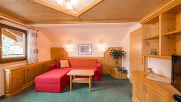 Deluxe Condo | Living area | 32-inch flat-screen TV with satellite channels, TV