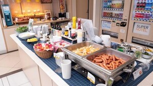 A buffet area with various food options, a vending machine, and a sign for the Super Hotel.