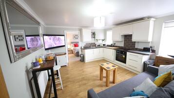 Deluxe Apartment, 1 Bedroom | Living area | Flat-screen TV, Netflix, streaming services