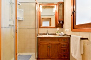 Bathtub, hair dryer, towels, toilet paper