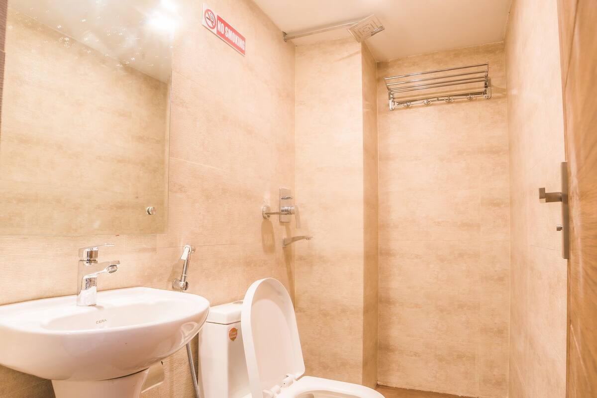 deluxe room | bathroom | shower, rainfall showerhead, free toiletries, slippers