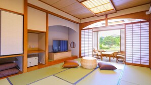 A traditional Japanese room with tatami flooring, a television, and a view of a garden. - Ooedo Onsen Monogatari Premium Hotel Sokan (Matsushima)