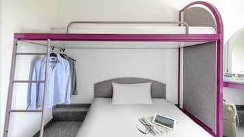 A bunk bed with a ladder, a small desk, and a mirror.