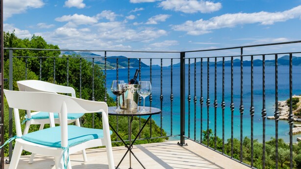 A balcony with a table set for two, overlooking a scenic coastal view. - Villa Sofija - Three Bedroom Villa with Terrace and Swimming Pool (Zaton Doli)